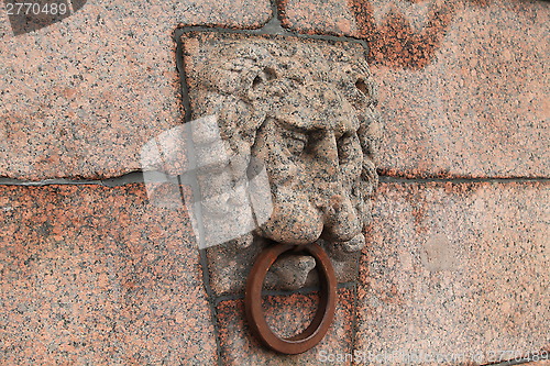 Image of granite lion's head with an iron ring 