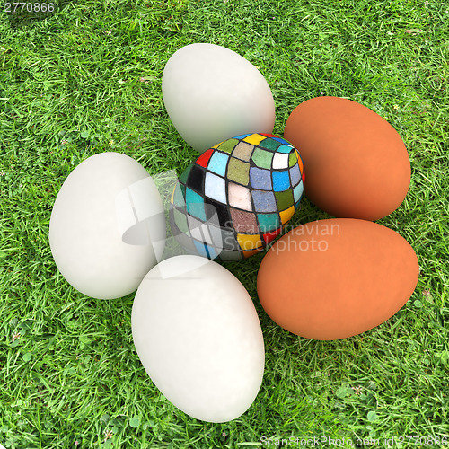 Image of Eggs and easter eggs on the grass