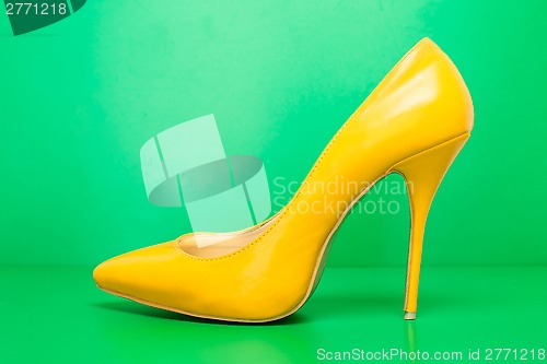 Image of single yellow high heels