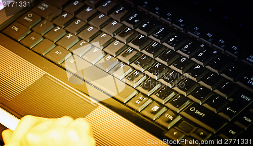 Image of Working at laptop .