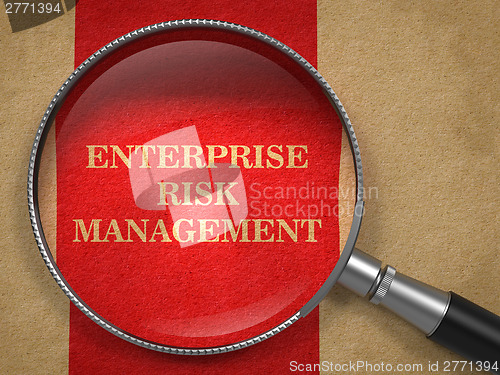 Image of Enterprise Risk Management. Magnifying Glass on Old Paper.