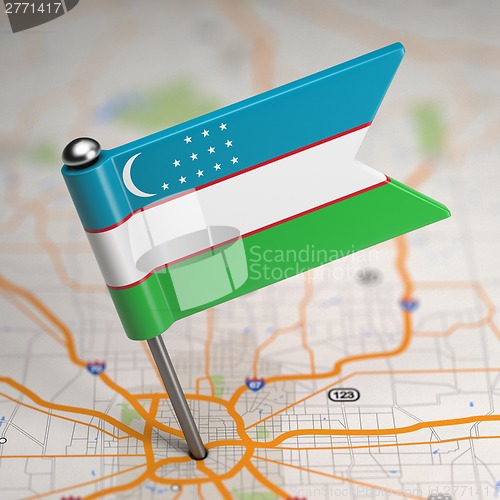 Image of Uzbekistan Small Flag on a Map Background.