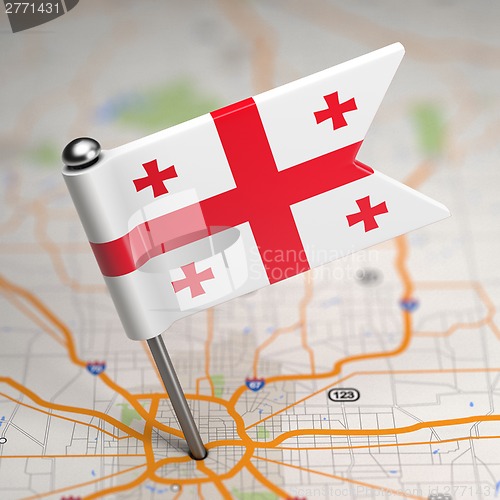 Image of Georgia Small Flag on a Map Background.