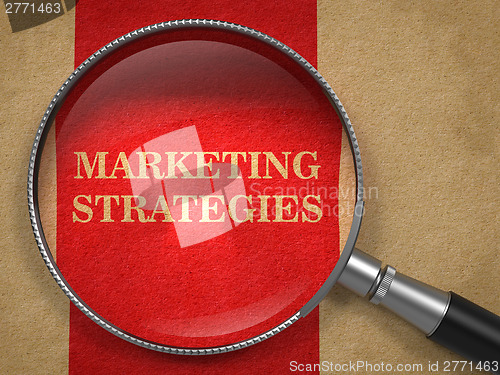 Image of Marketing Strategies. Magnifying Glass on Old Paper.