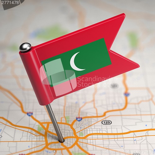 Image of Maldives Small Flag on a Map Background.