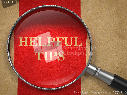 Image of Helpful Tips. Magnifying Glass on Old Paper.