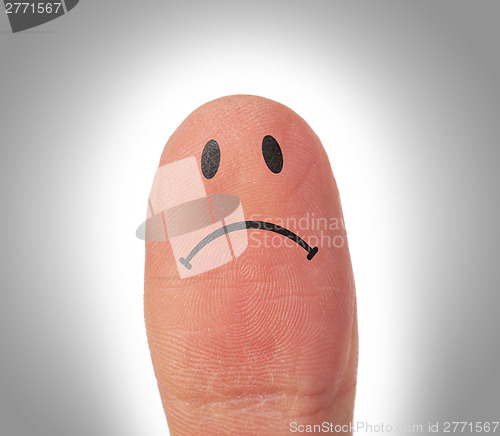 Image of Female thumbs with smile face on the finger