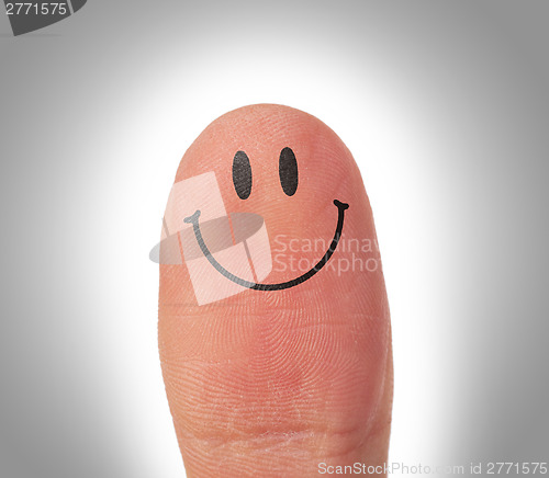 Image of Female thumbs with smile face on the finger