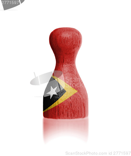 Image of Wooden pawn with a flag painting