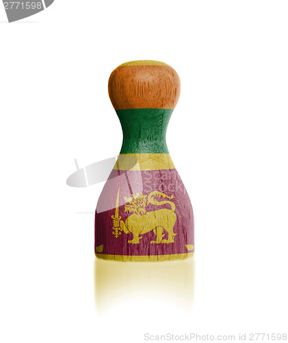 Image of Wooden pawn with a flag painting