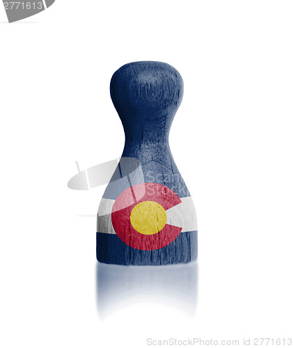 Image of Wooden pawn with a flag painting