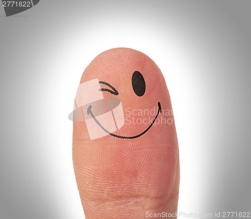 Image of Female thumbs with smile face on the finger