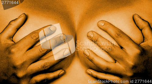 Image of Hands covering breasts