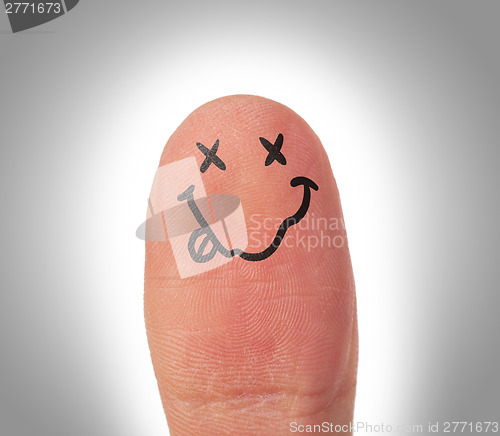 Image of Female thumbs with smile face on the finger