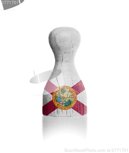 Image of Wooden pawn with a flag painting