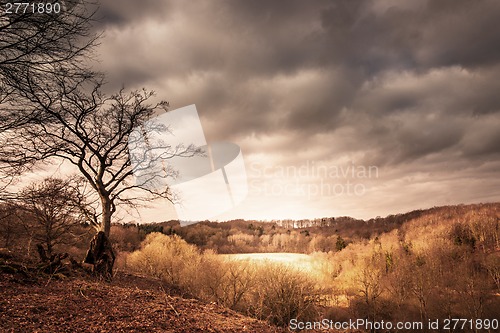 Image of Dramatic landscape of a valley with sunshine shining through dar
