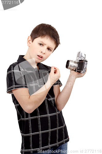 Image of young boy with old vintage analog SLR camera