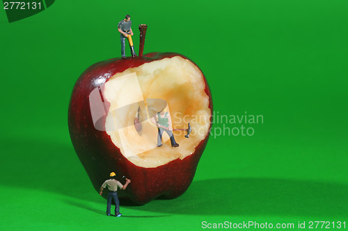 Image of Construction Workers in Conceptual Imagery With an Apple