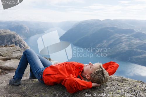 Image of Woman hiker on Pulpit Rock / Preikestolen, Norway