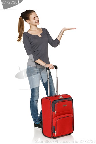 Image of Young casual girl in full length with suitcase