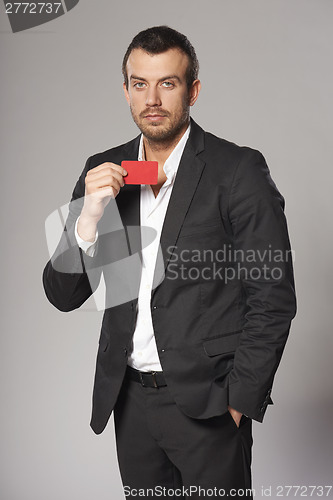 Image of Relaxed fashionable man in suit standing casually