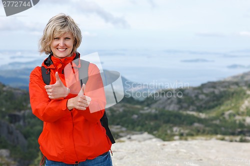 Image of Happy woman gesturing thumbs up