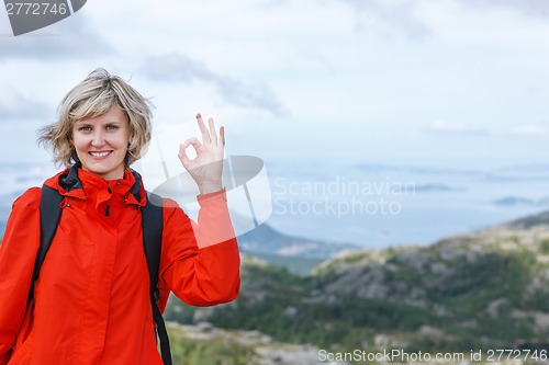 Image of Happy woman gesturing thumbs up