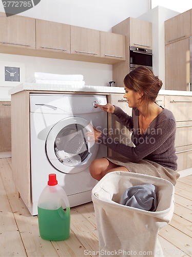 Image of woman loading the washing machine