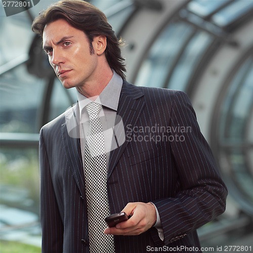 Image of businessman using mobile phone black l