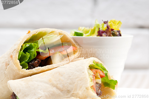 Image of kafta shawarma chicken pita wrap roll sandwich