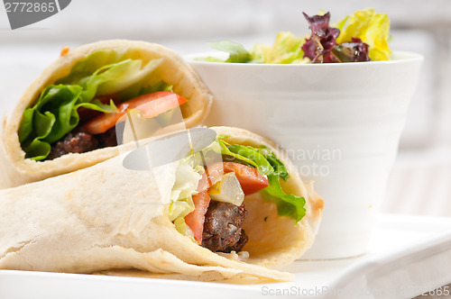 Image of kafta shawarma chicken pita wrap roll sandwich