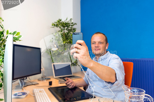 Image of Business man taking a selfie.