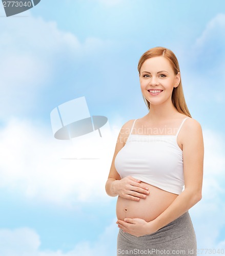 Image of happy future mother touching her belly