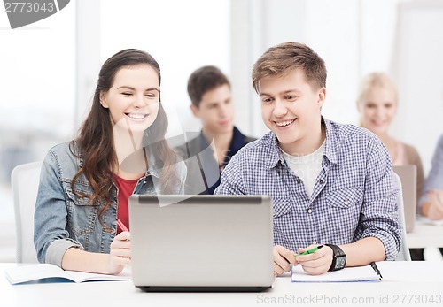 Image of students with laptop and notebooks at school