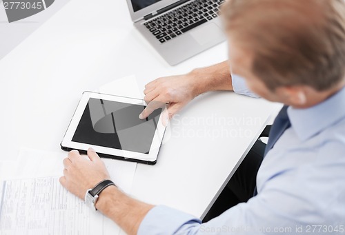 Image of businessman with tablet pc in office