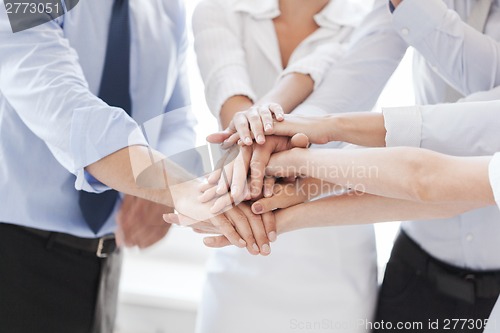 Image of business team celebrating victory in office