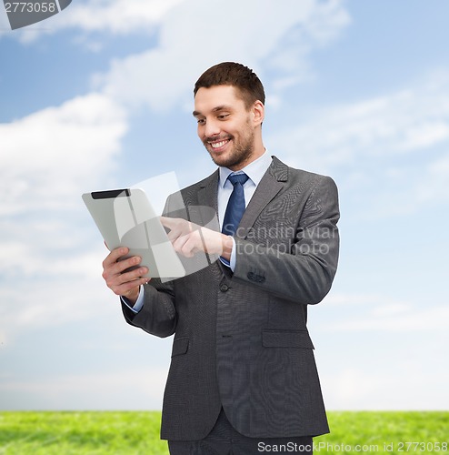 Image of smiling buisnessman with tablet pc computer