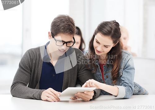 Image of students looking at tablet pc in lecture at school