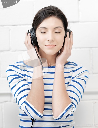 Image of happy teenage girl in big headphones