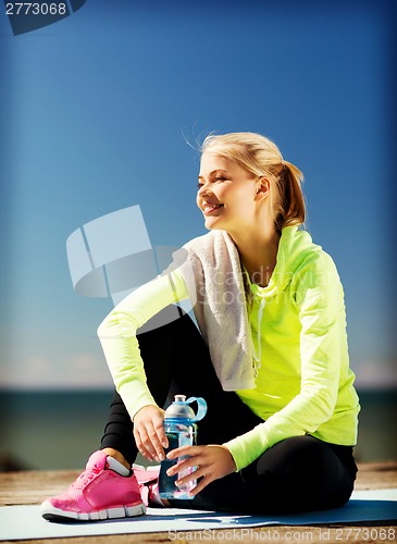Image of woman resting after doing sports outdoors