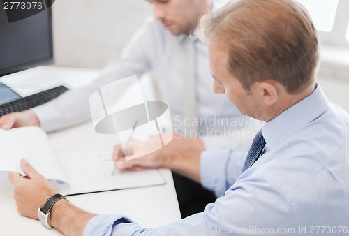 Image of businessmen with notebook on meeting