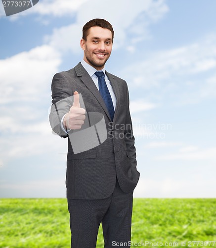 Image of handsome buisnessman showing thumbs up