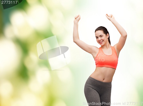 Image of smiling teenage girl in sportswear dancing