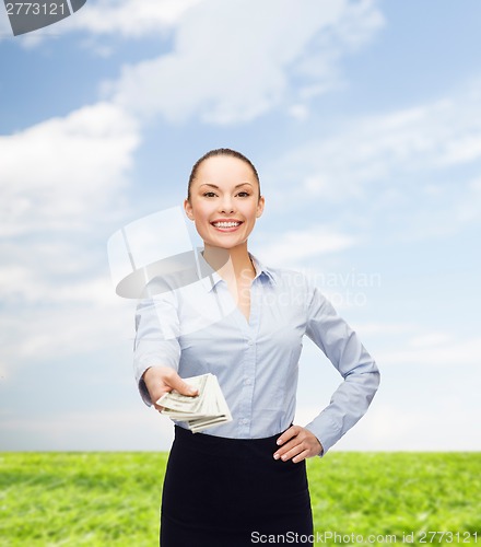 Image of young businesswoman with dollar cash money