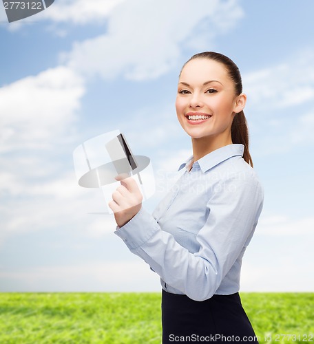 Image of smiling businesswoman showing credit card