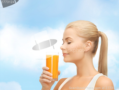 Image of young woman drinking orange juice