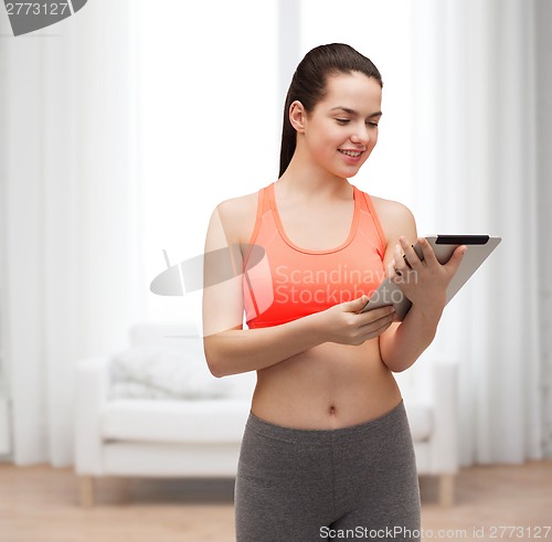 Image of sporty woman with tablet pc computer