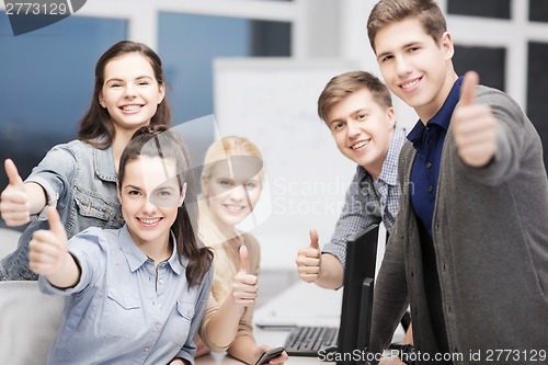 Image of students with computer monitor and smartphones