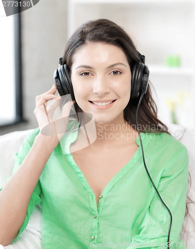 Image of happy teenage girl in big headphones