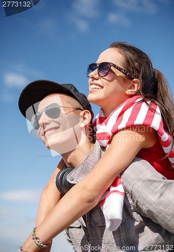Image of smiling teenagers in sunglasses having fun outside